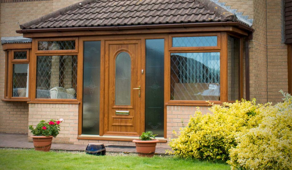 Oak colour upvc entrance door with arched pane of glass Poole