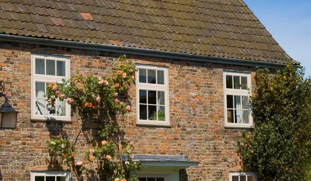 Flush sash windows in white on a traditional red brick property Weymouth