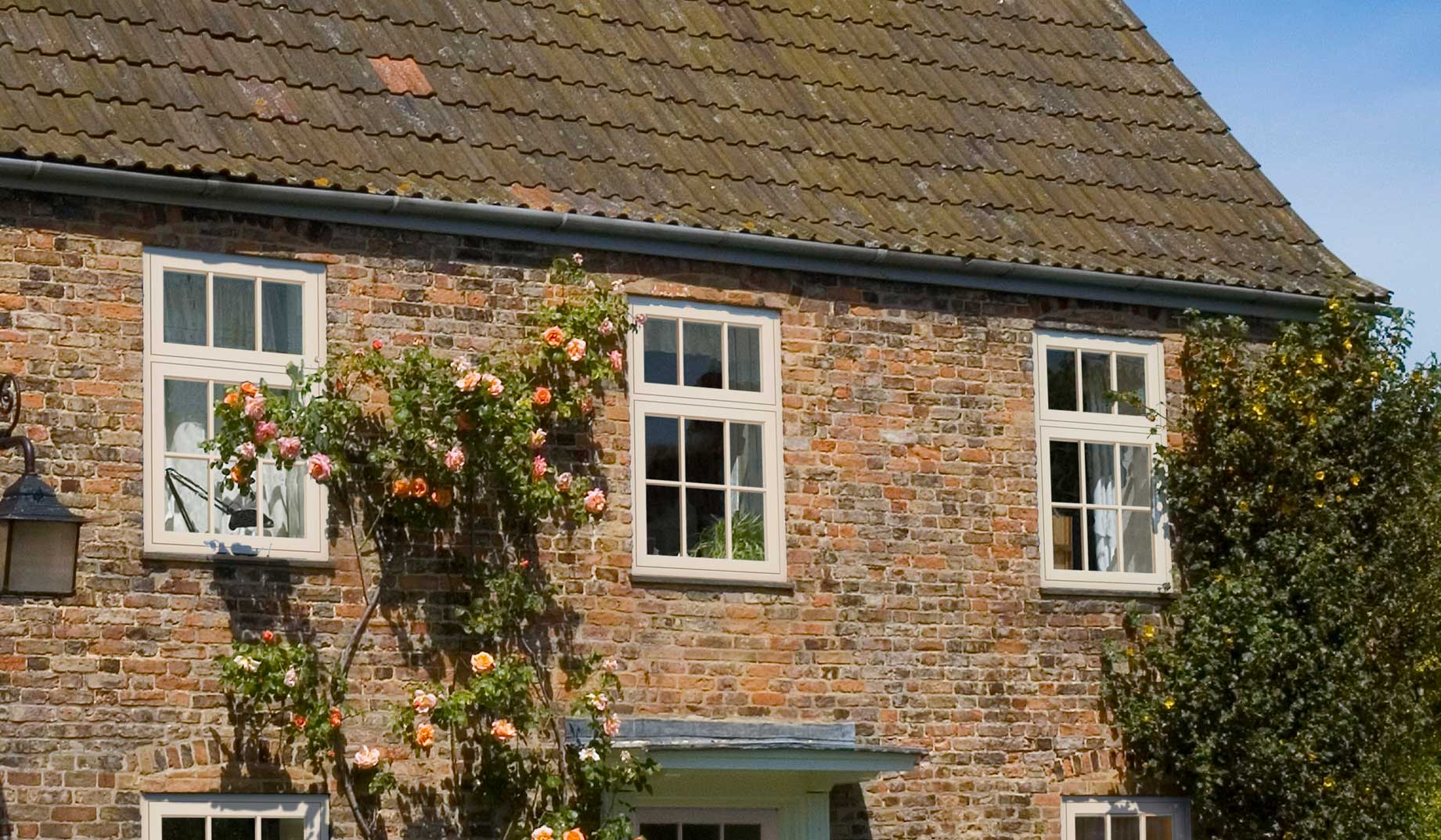 Flush sash windows in white on a traditional red brick property Weymouth