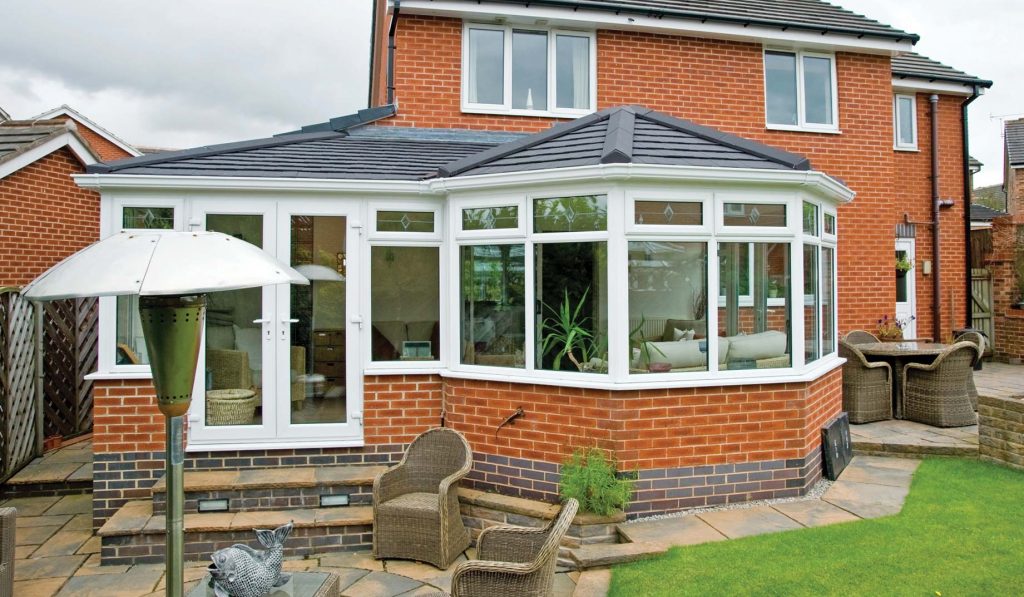Grey tiled roof conservatory with red brick to match existing property Portland