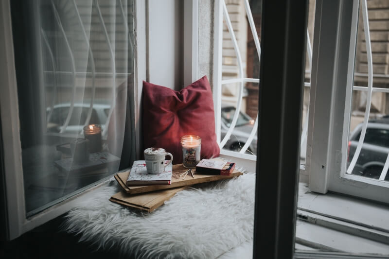 A candle glass with red pillow