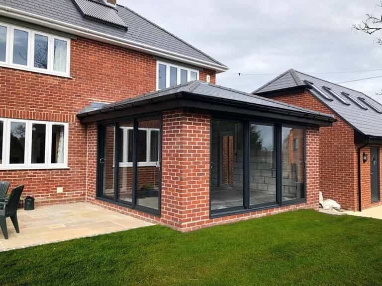 Summerhouse with anthracite grey sliding aluminium doors Dorchester